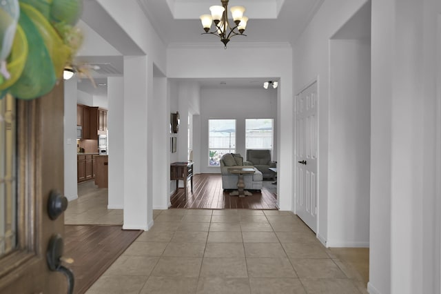16923 Fondness Park Dr, Spring, TX 77379 - entryway with light tile patterned flooring, a chandelier, crown molding, and baseboards
