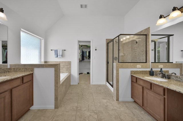16923 Fondness Park Dr, Spring, TX 77379 - full bathroom featuring a shower stall, a spacious closet, two vanities, tile patterned floors, and vaulted ceiling