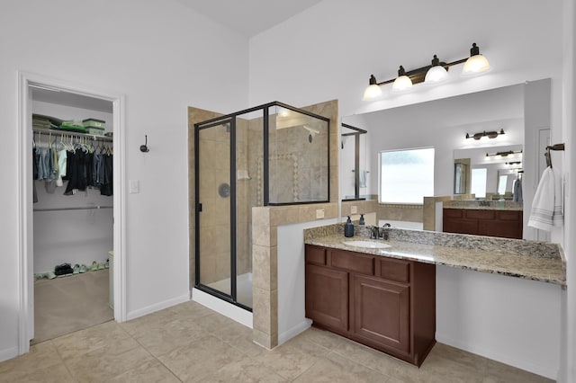 16923 Fondness Park Dr, Spring, TX 77379 - bathroom with a stall shower, a spacious closet, vanity, and baseboards