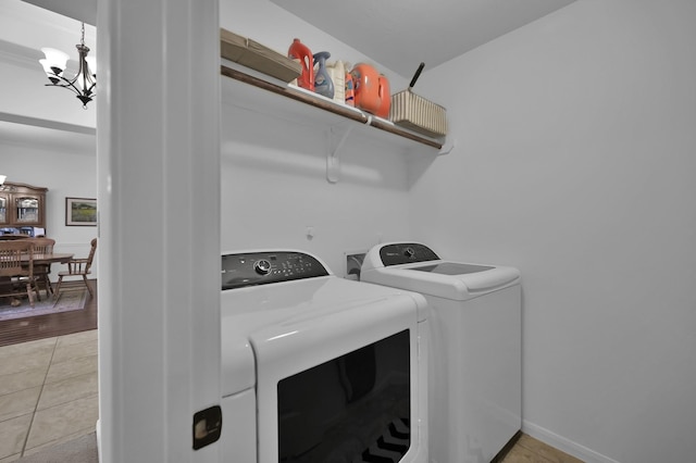 16923 Fondness Park Dr, Spring, TX 77379 - laundry area with washing machine and dryer, a chandelier, and light tile patterned flooring
