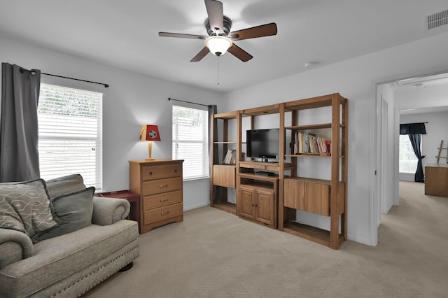 16923 Fondness Park Dr, Spring, TX 77379 - living area with light carpet, a ceiling fan, and baseboards