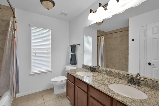 16923 Fondness Park Dr, Spring, TX 77379 - bathroom featuring double vanity, tile patterned floors, toilet, shower / bath combo with shower curtain, and baseboards