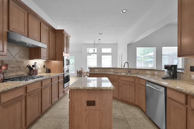 16923 Fondness Park Dr, Spring, TX 77379 - kitchen with appliances with stainless steel finishes, under cabinet range hood, a sink, backsplash, and light stone countertops