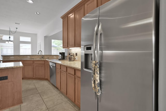16923 Fondness Park Dr, Spring, TX 77379 - kitchen featuring appliances with stainless steel finishes, a sink, light stone counters, a peninsula, and recessed lighting