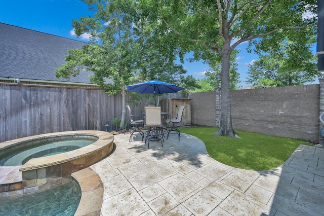 16923 Fondness Park Dr, Spring, TX 77379 - fenced backyard featuring an in-ground hot tub, a patio, and outdoor dining area