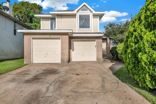1535 Carbonear Dr, Channelview, TX 77530 - view of front facade featuring brick siding, driveway, and a garage