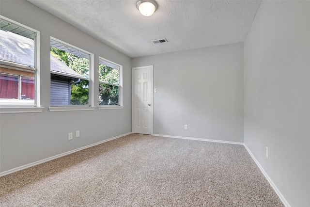 1535 Carbonear Dr, Channelview, TX 77530 - spare room featuring carpet floors, healthy amount of natural light, a textured ceiling, and baseboards