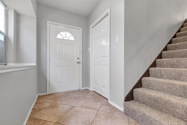 1535 Carbonear Dr, Channelview, TX 77530 - entrance foyer featuring stairway, light tile patterned floors, and baseboards
