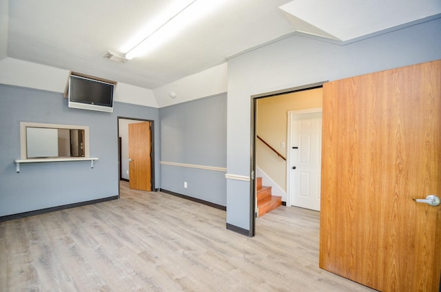 6623 Gulf Fwy, Houston, TX 77087 - unfurnished bedroom with lofted ceiling, wood finished floors, and baseboards