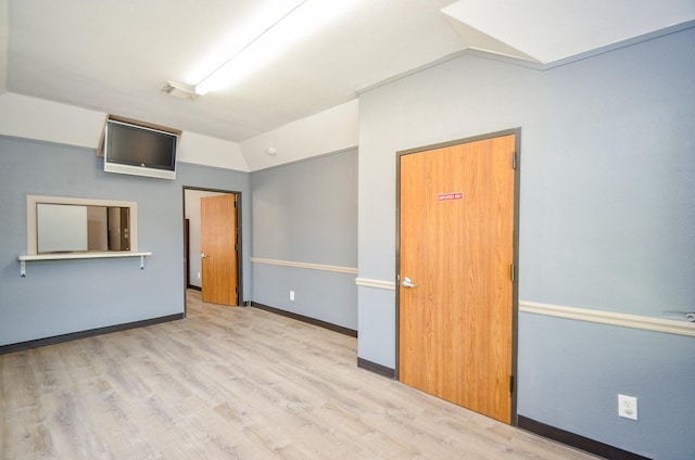 6623 Gulf Fwy, Houston, TX 77087 - unfurnished bedroom with lofted ceiling, wood finished floors, and baseboards