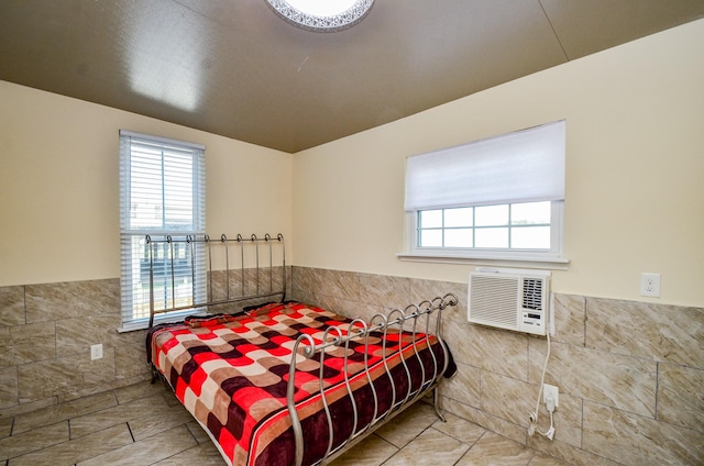6623 Gulf Fwy, Houston, TX 77087 - tiled bedroom with tile walls, wainscoting, multiple windows, and a wall mounted AC