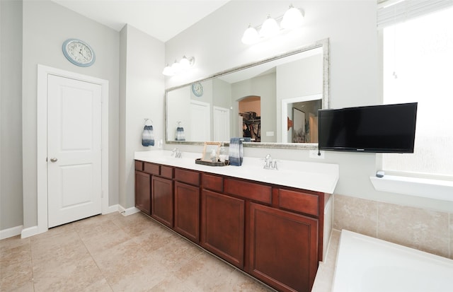 16826 Paynes Creek Dr, Cypress, TX 77433 - full bath with double vanity, a spacious closet, a garden tub, and baseboards