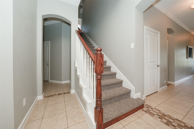 16826 Paynes Creek Dr, Cypress, TX 77433 - staircase with tile patterned floors, arched walkways, and baseboards