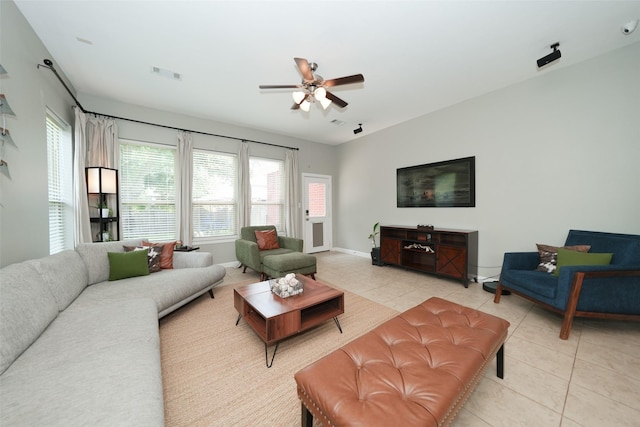 16826 Paynes Creek Dr, Cypress, TX 77433 - living area with light tile patterned flooring, ceiling fan, and baseboards