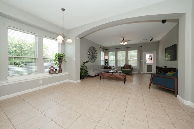 16826 Paynes Creek Dr, Cypress, TX 77433 - living area with light tile patterned floors, arched walkways, a ceiling fan, and baseboards
