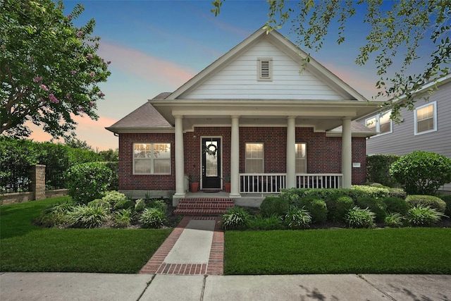 16826 Paynes Creek Dr, Cypress, TX 77433 - view of front of property featuring brick siding, covered porch, and a yard