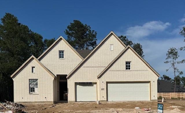 16155 Rustling Woods Rd, Conroe, TX 77302 - view of front of home featuring brick siding and driveway
