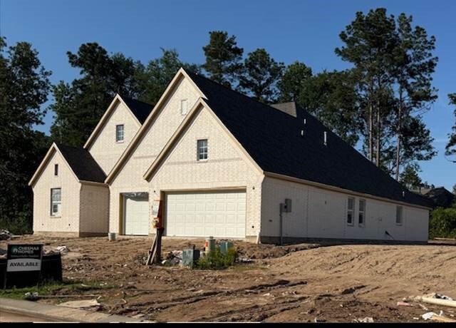 16155 Rustling Woods Rd, Conroe, TX 77302 - view of side of property featuring an attached garage