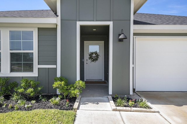31723 Kellan Grove Ct, Fulshear, TX 77441 - view of exterior entry with a shingled roof, board and batten siding, and an attached garage