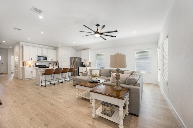 31723 Kellan Grove Ct, Fulshear, TX 77441 - living area featuring baseboards, a ceiling fan, light wood-style flooring, and recessed lighting
