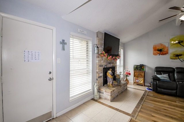 4623 Tealgate Dr, Spring, TX 77373 - foyer with lofted ceiling, a ceiling fan, light tile patterned floors, baseboards, and a fireplace