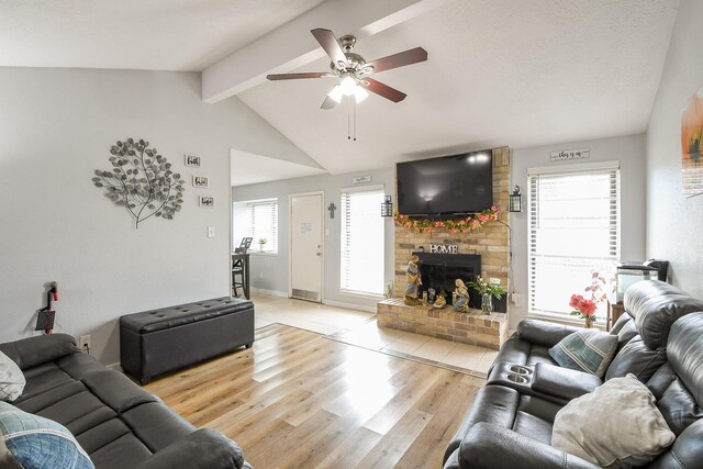 4623 Tealgate Dr, Spring, TX 77373 - living room featuring light wood-style floors, ceiling fan, a fireplace, and baseboards