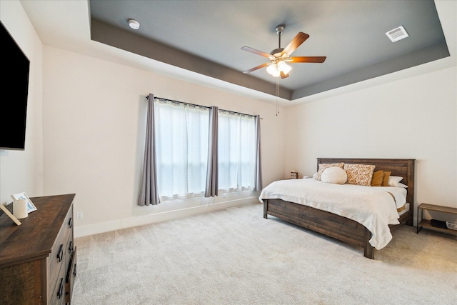 12434 Tullich Run Dr, Humble, TX 77346 - carpeted bedroom featuring a raised ceiling, ceiling fan, and baseboards