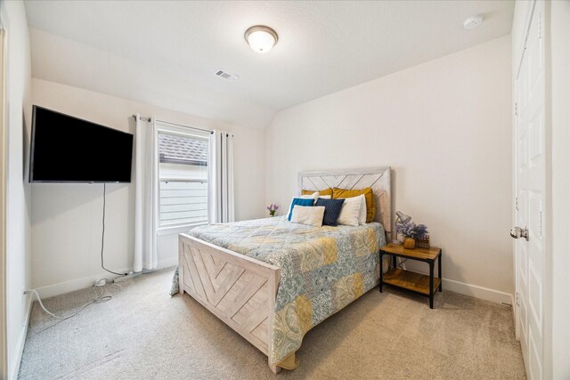 12434 Tullich Run Dr, Humble, TX 77346 - bedroom featuring light carpet, baseboards, and lofted ceiling