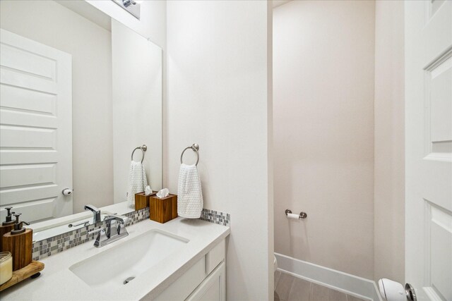 12434 Tullich Run Dr, Humble, TX 77346 - half bath featuring vanity, baseboards, and wood finished floors