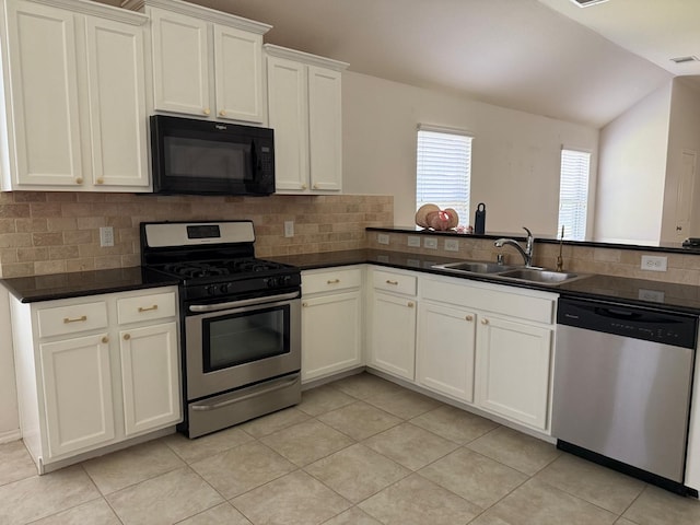 3643 Goldleaf Trail Dr, Katy, TX 77449 - kitchen with stainless steel appliances, a sink, light tile patterned floors, tasteful backsplash, and lofted ceiling