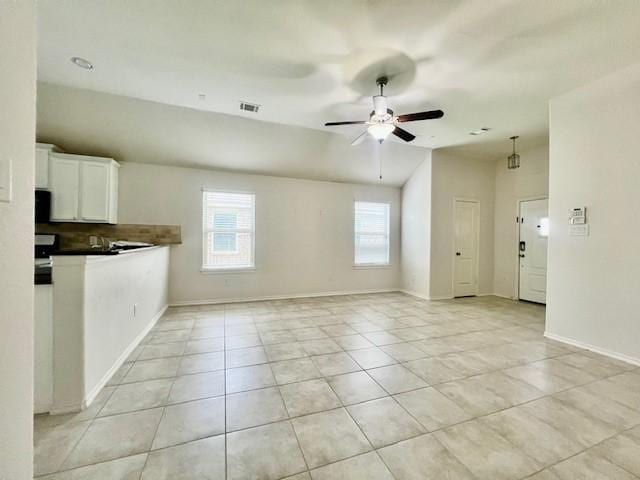 3643 Goldleaf Trail Dr, Katy, TX 77449 - unfurnished living room with light tile patterned flooring, a ceiling fan, baseboards, and vaulted ceiling
