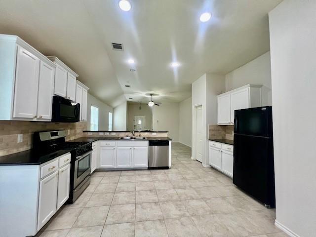 3643 Goldleaf Trail Dr, Katy, TX 77449 - kitchen with appliances with stainless steel finishes, a peninsula, tasteful backsplash, dark countertops, and white cabinetry