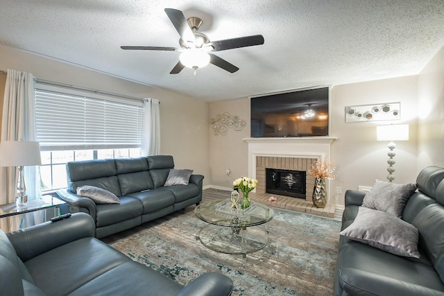 19727 Teller Blvd, Spring, TX 77388 - living area with ceiling fan, a textured ceiling, baseboards, a brick fireplace, and wood finished floors