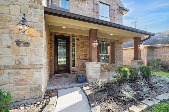 1811 Leela Springs Dr, Conroe, TX 77304 - view of exterior entry featuring stone siding, brick siding, and covered porch