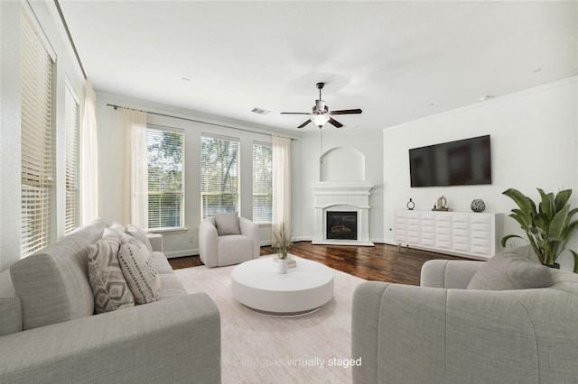 1811 Leela Springs Dr, Conroe, TX 77304 - living area with wood finished floors, a ceiling fan, crown molding, and a glass covered fireplace