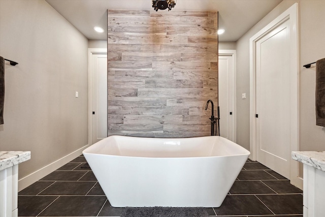 5121 Elysian St, Houston, TX 77009 - bathroom featuring tile patterned flooring, a freestanding bath, baseboards, and recessed lighting