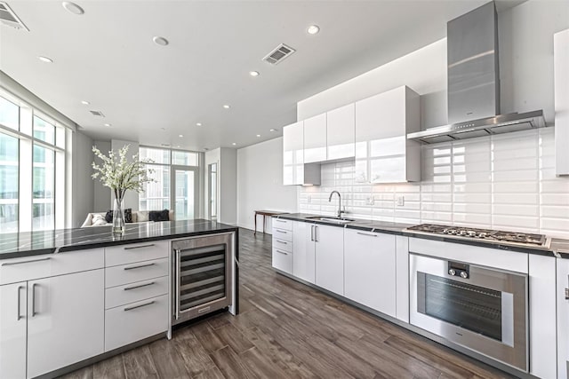 4521 San Felipe St Unit 1203, Houston, TX 77027 - kitchen with appliances with stainless steel finishes, wall chimney range hood, wine cooler, modern cabinets, and a sink