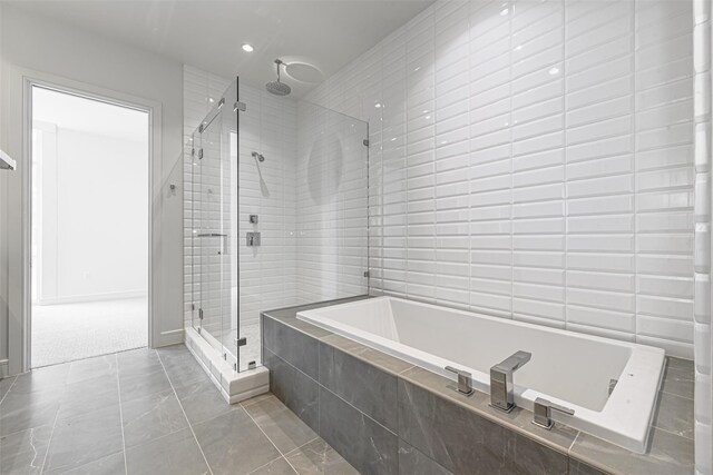 4521 San Felipe St Unit 1203, Houston, TX 77027 - bathroom with a bath, a stall shower, recessed lighting, and tile patterned floors
