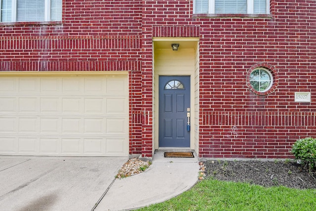 15027 Silhouette Ridge Dr, Humble, TX 77396 - view of exterior entry featuring brick siding and driveway