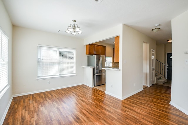 15027 Silhouette Ridge Dr, Humble, TX 77396 - kitchen with stainless steel refrigerator with ice dispenser, light countertops, a chandelier, and wood finished floors