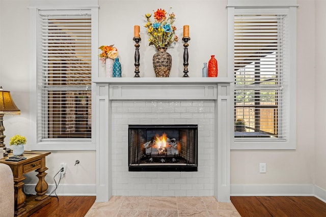 2532 Hailes Ln, College Station, TX 77845 - detailed view of baseboards, wood finished floors, and a fireplace