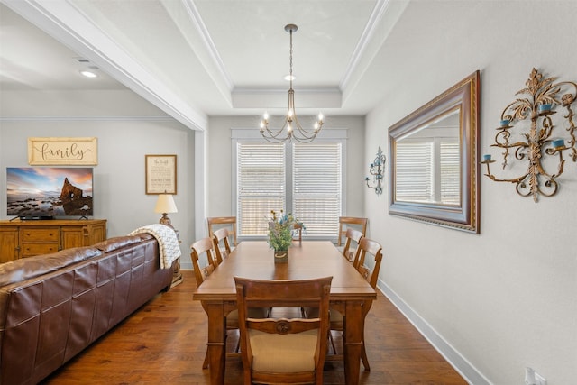 2532 Hailes Ln, College Station, TX 77845 - dining area featuring a chandelier, a raised ceiling, ornamental molding, healthy amount of natural light, and dark wood-style floors