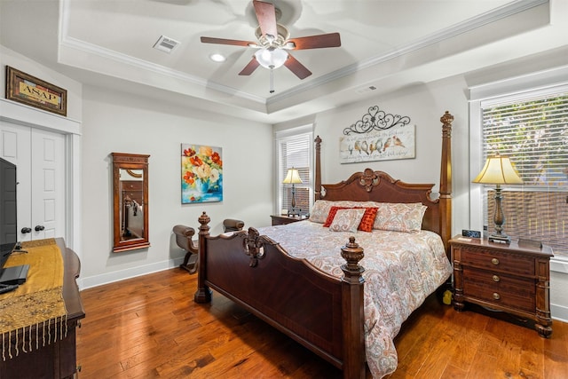 2532 Hailes Ln, College Station, TX 77845 - bedroom with a tray ceiling, ornamental molding, multiple windows, wood-type flooring, and recessed lighting