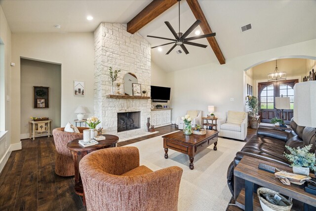 21319 Rosehill Church Rd, Tomball, TX 77377 - living area with arched walkways, beam ceiling, ceiling fan, a fireplace, and hardwood / wood-style flooring