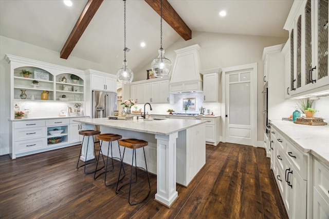 21319 Rosehill Church Rd, Tomball, TX 77377 - kitchen with open shelves, a sink, white cabinets, a breakfast bar, and a center island with sink