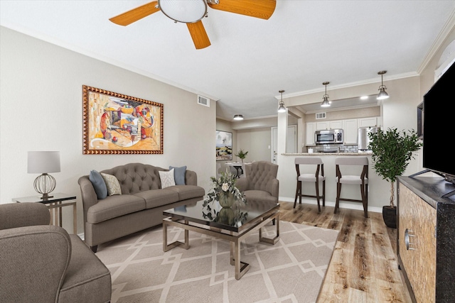 4649 Wild Indigo St Unit 340, Houston, TX 77027 - living area with light wood finished floors, ornamental molding, and ceiling fan