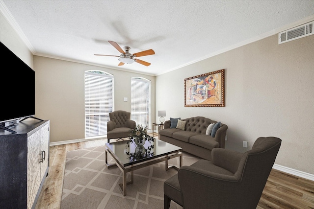 4649 Wild Indigo St Unit 340, Houston, TX 77027 - living room with crown molding, wood finished floors, ceiling fan, a textured ceiling, and baseboards