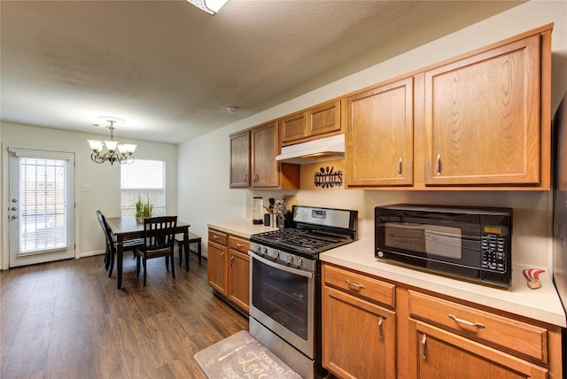 2910 Yearling Colt Ct, Houston, TX 77038 - kitchen with stainless steel gas range oven, under cabinet range hood, black microwave, a chandelier, and light countertops