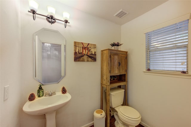 2910 Yearling Colt Ct, Houston, TX 77038 - half bathroom featuring baseboards, toilet, and a sink
