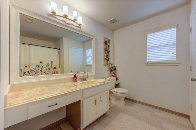 2910 Yearling Colt Ct, Houston, TX 77038 - full bath with vanity, toilet, wood finished floors, baseboards, and healthy amount of natural light
